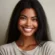 DALL·E 2024-05-22 12.46.43 - A happy brown-skinned woman with long black hair, a cheerful smile, and bright eyes. She is wearing a casual shirt and is in a relaxed setting. The ba